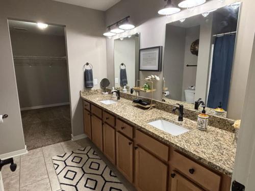 a bathroom with two sinks and a large mirror at Beautiful 3 bed 2 bath condo in Loves Park