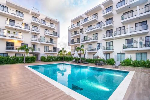 a swimming pool in front of a building at Luxury Apartment, Pool, Close to the Beach in Punta Cana