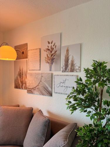 a living room with pictures on the wall at Peak11 Fewo- Panorama View Lahnstein Pool & Sauna in Lahnstein