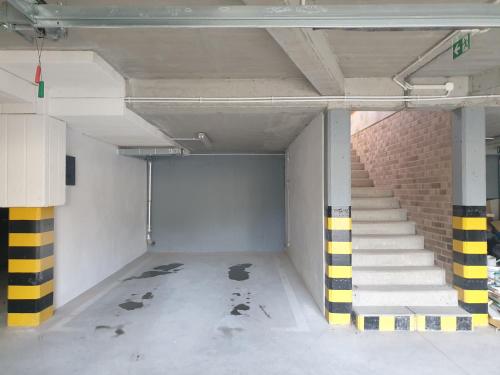 an empty parking lot with stairs in a building at Near the airport- Apartments in Kraków