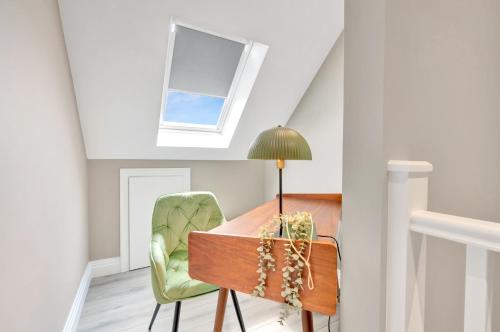 a room with a table and a lamp and a chair at Travard at Heathrow 386 in Harmondsworth