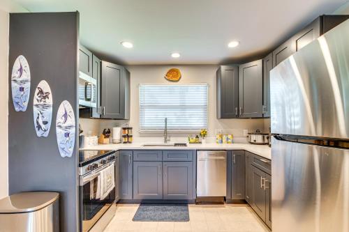 a kitchen with gray cabinets and stainless steel appliances at Direct Gulf Access Hernando Beach Escape! in Hernando Beach