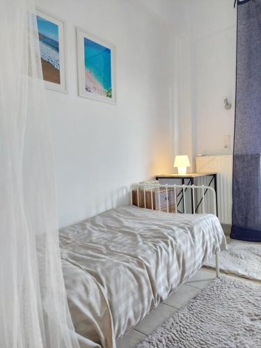 a white bedroom with a bed with a canopy at Doras House in village Άνετο Διαμέρισμα υπέροχη θέα in Pyrgadikia