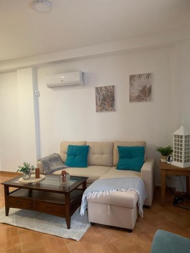 a living room with a couch and a coffee table at Casa Abuela Cati in Sanlúcar de Guadiana
