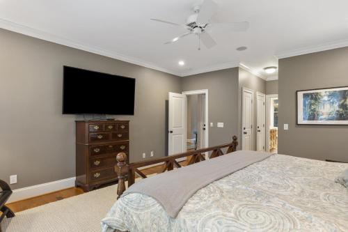 a bedroom with a bed and a flat screen tv at 14 Angler Hall by Akers Ellis Rentals in Kiawah Island