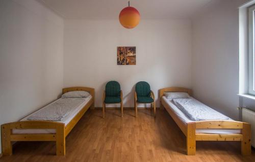 a hospital room with two beds and two chairs at Ferienwohnung Glaser in Pforzheim