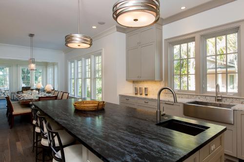 a kitchen with a large island with a counter top at 165 Surfsong Road by Akers Ellis Rentals in Kiawah Island