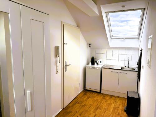 a small kitchen with a sink and a window at Loftstyle Wohnung in Wiesbaden in Wiesbaden