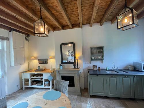 a room with a sink and a mirror and a table at Gite de Fleur - Chateau du Grand Luçay in Bourbon-lʼArchambault