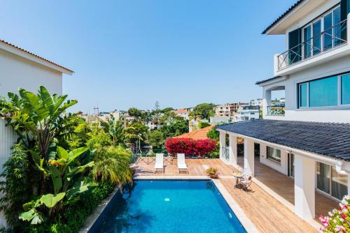 an image of a house with a swimming pool at Mbird Estoril Riviera Flat 3 in Estoril