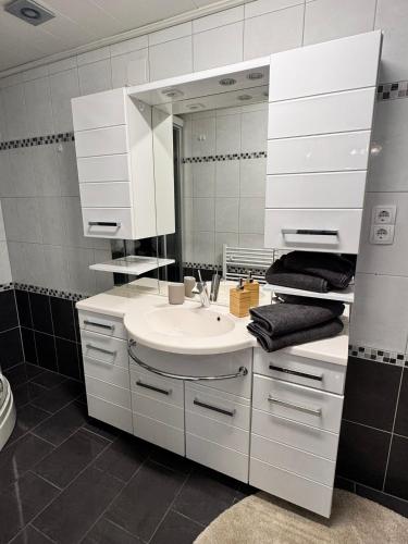 a white bathroom with a sink and a mirror at Ferienwohnung-Mixnitz-Bärenschützklamm 3 in Mixnitz