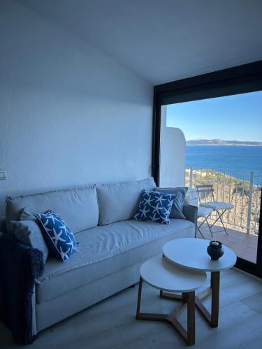 a living room with a couch and a table at Sa Calma - Cap Sa Sal Begur in Isla Negra