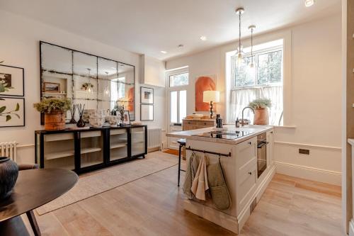 a large kitchen with a sink and a counter at Alfred's Ramsbottom - Suite Two in Ramsbottom