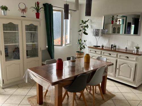 a kitchen with a wooden table and chairs at Landaise 10765902 in Tarnos