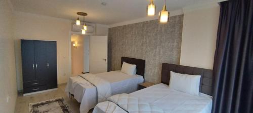 a hotel room with two beds and a mirror at Nora Marmara Luxury Villas in Istanbul in Buyukcekmece