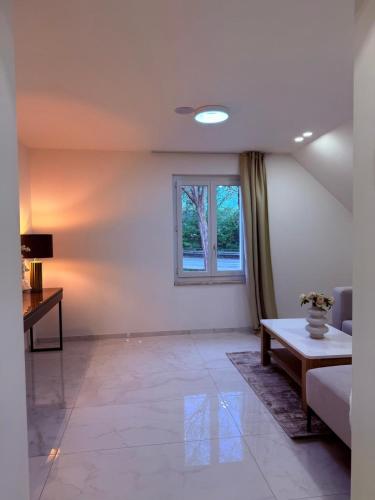 a living room with a couch and a window at Luxrem 5 Apartments Skyline in Biel