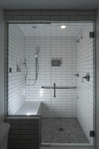 a shower with a glass door in a bathroom at Riverboat Suites in Galena