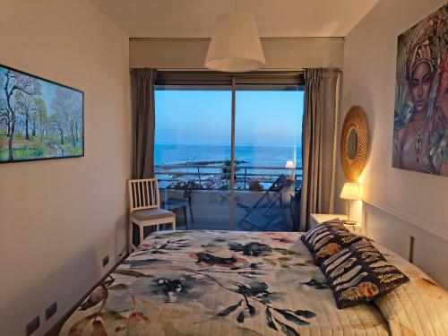 a bedroom with a bed with a view of the ocean at BLOOM al Mare in Ventimiglia