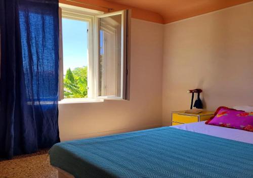 a bedroom with a bed and a window at Large house & swimming pool in downtown Arles in Arles