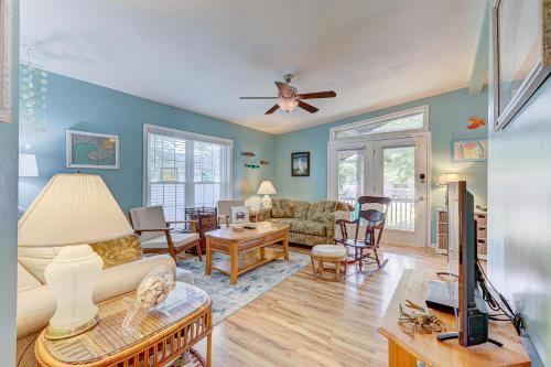 a living room with a couch and a table at Gone Coastal by Carolina Beach Realty in Carolina Beach