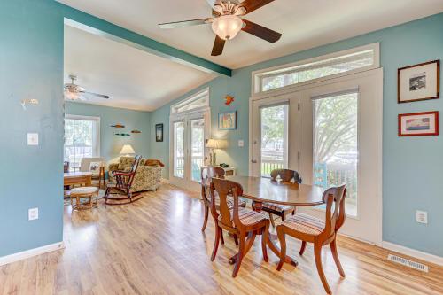 a dining room and living room with a table and chairs at Gone Coastal by Carolina Beach Realty in Carolina Beach