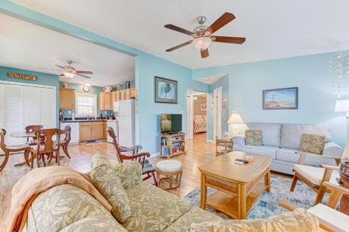 a living room with a couch and a table at Gone Coastal by Carolina Beach Realty in Carolina Beach