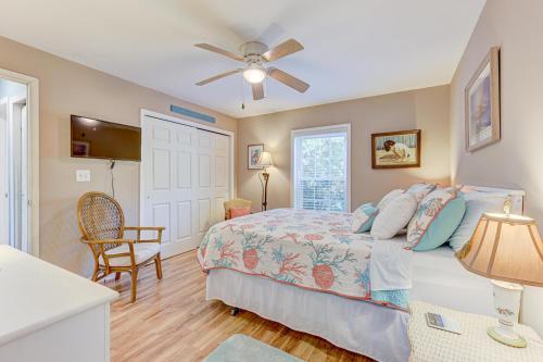 a bedroom with a bed and a ceiling fan at Gone Coastal by Carolina Beach Realty in Carolina Beach
