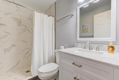 a bathroom with a toilet and a sink and a shower at Gone Coastal by Carolina Beach Realty in Carolina Beach