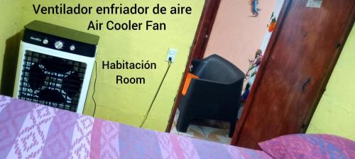 a room with an air cooler fan and a television at Vista del Mar in Acajutla