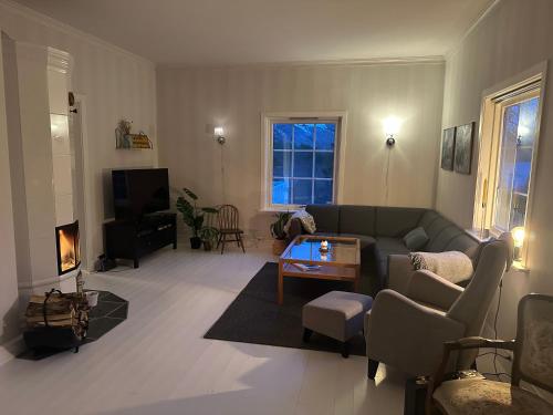 a living room with a couch and a tv at Heggmoen Lodge in Bodø