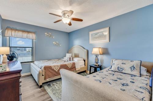 a bedroom with two beds and a couch at Winds VI F3 by Carolina Beach Realty in Carolina Beach