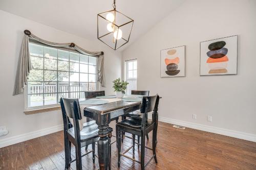 a dining room with a table and chairs and a window at 2 Mi to Badger Mountain Hot Tub Haven! in Richland