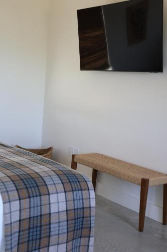 a bedroom with a bed and a table and a tv at The Martinsburg in Stonewall