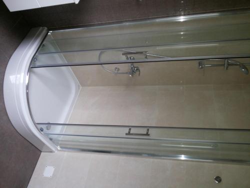 a glass shower in a bathroom with a mirror at Dalmacija Gradac in Gradac