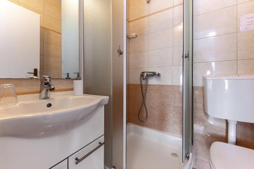a bathroom with a sink and a shower at Bed and Breakfast Ivona in Baška Voda