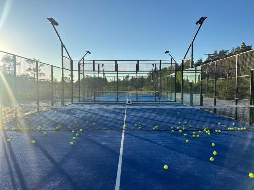 a tennis court with tennis balls on it at Hapsal Spa Villas in Haapsalu