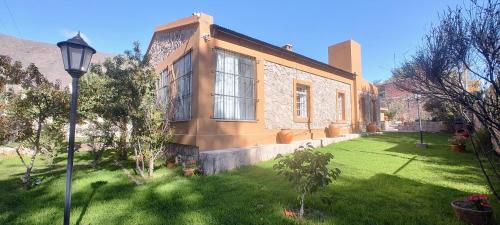 a house with a street light in front of a yard at Estación Tilcara boutique hotel in Tilcara