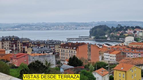 a city with buildings and a body of water at Apartamento CORAZÓN DE MIÑO in Miño