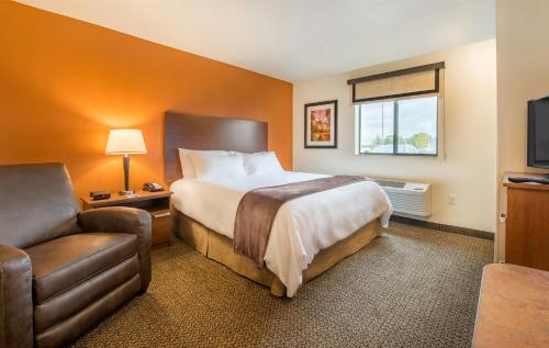 a hotel room with a bed and a chair at My Place Hotel-Lubbock, TX in Lubbock