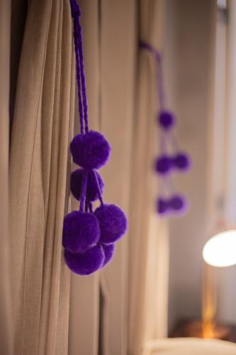 a bunch of purple stuffed animals hanging from a shower curtain at Estación Tilcara boutique hotel in Tilcara