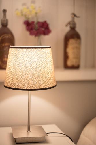 a lamp sitting on a table in a living room at Estación Tilcara boutique hotel in Tilcara