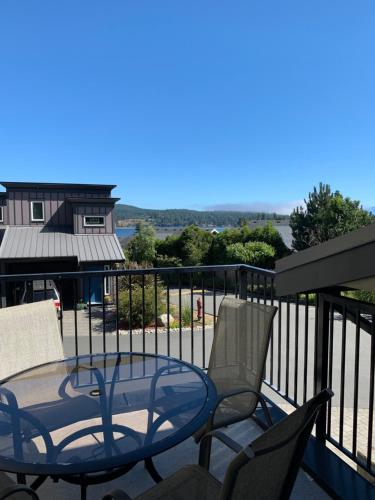 a patio with a table and chairs on a balcony at Sooke Harbour Getaway in Sooke