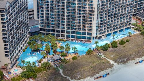 an aerial view of a large swimming pool in a city at Modern Oceanfront 1 Bedroom Condo, Prime Location, Stunning Views at Beach Cove Resort in Myrtle Beach