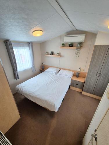 a bedroom with a large white bed in a room at Whitstable Vacation in Kent