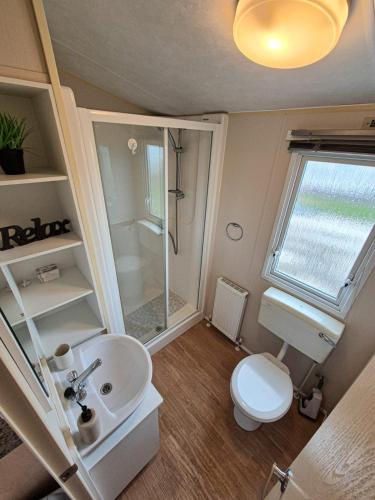 a small bathroom with a sink and a toilet at Whitstable Vacation in Kent