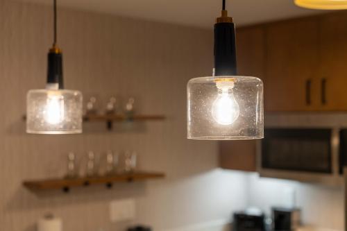 three lights hanging from the ceiling in a kitchen at Residence Inn by Marriott San Luis Obispo in San Luis Obispo
