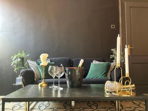 a living room with a table with glasses and candles at Flow - City Centre Zadar in Zadar