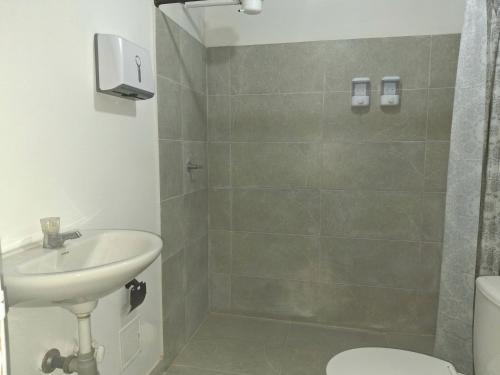 a bathroom with a shower and a sink and a toilet at Casa Bella Vista in Bogotá