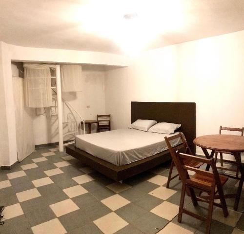 ein Schlafzimmer mit einem Bett und einem Tisch und Stühlen in der Unterkunft Hermosa Habitación en Samaipata in Santa Cruz de la Sierra