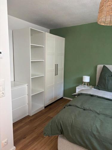 a bedroom with a bed and a white closet at Bergzauber in Pfronten